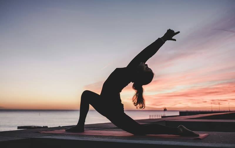 A yoga class in a sunlit studio